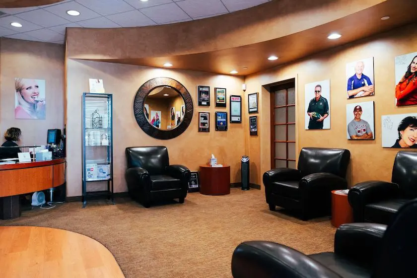 waiting room with many images ans awards on the wall at GOREgeous Smiles