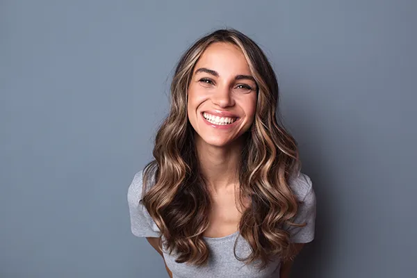 Joyful white woman showing off her beautiful teeth with a smile