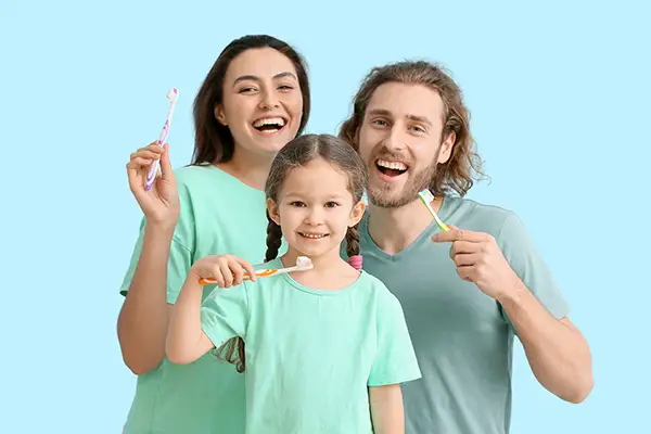 A family with parents and a young child visiting a Scottsdale dental office for routine preventive care.